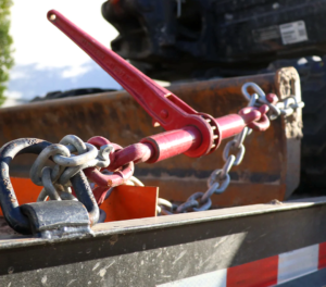 Ratchet load binder securing heavy cargo on truck trailer-
